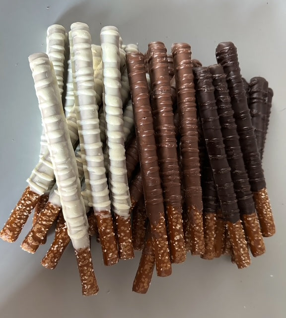 Sharing assortment of chocolate-covered pretzel rods