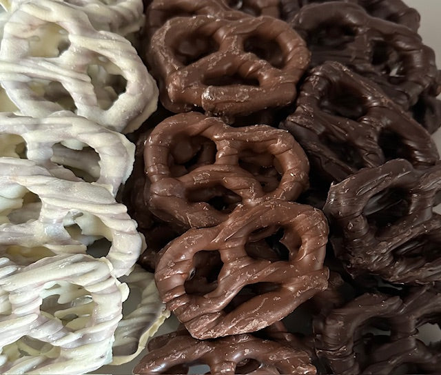 Assorted decorated chocolate pretzel twists in a gift box